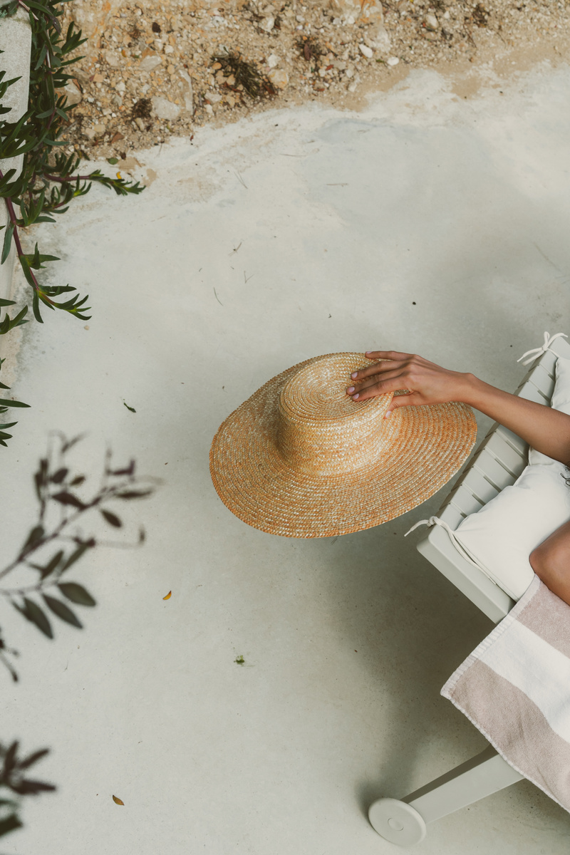 Pool Lifestyle Person Holding a Hat Outdoors