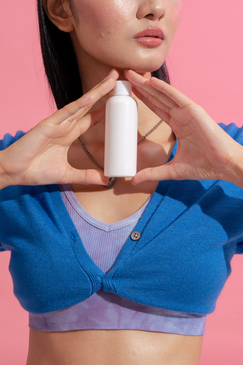 Woman Holding a Cosmetic Bottle
